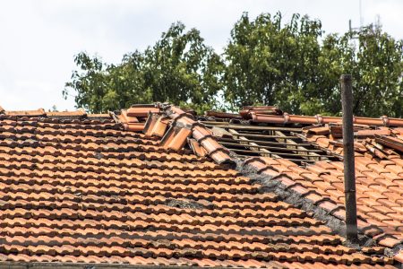 Damaged,Roof,Construction,On,House,Needs,Tiles,Or,Shingles,Repaired