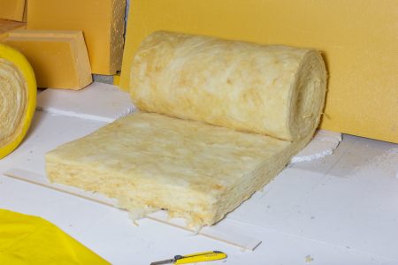 Rolled,Out,Thermal,Insulation,Role,In,Yellow,Package,At,Attic