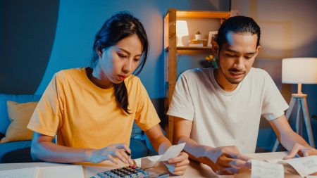 Stress asia couple man and woman use calculator for calculate fa